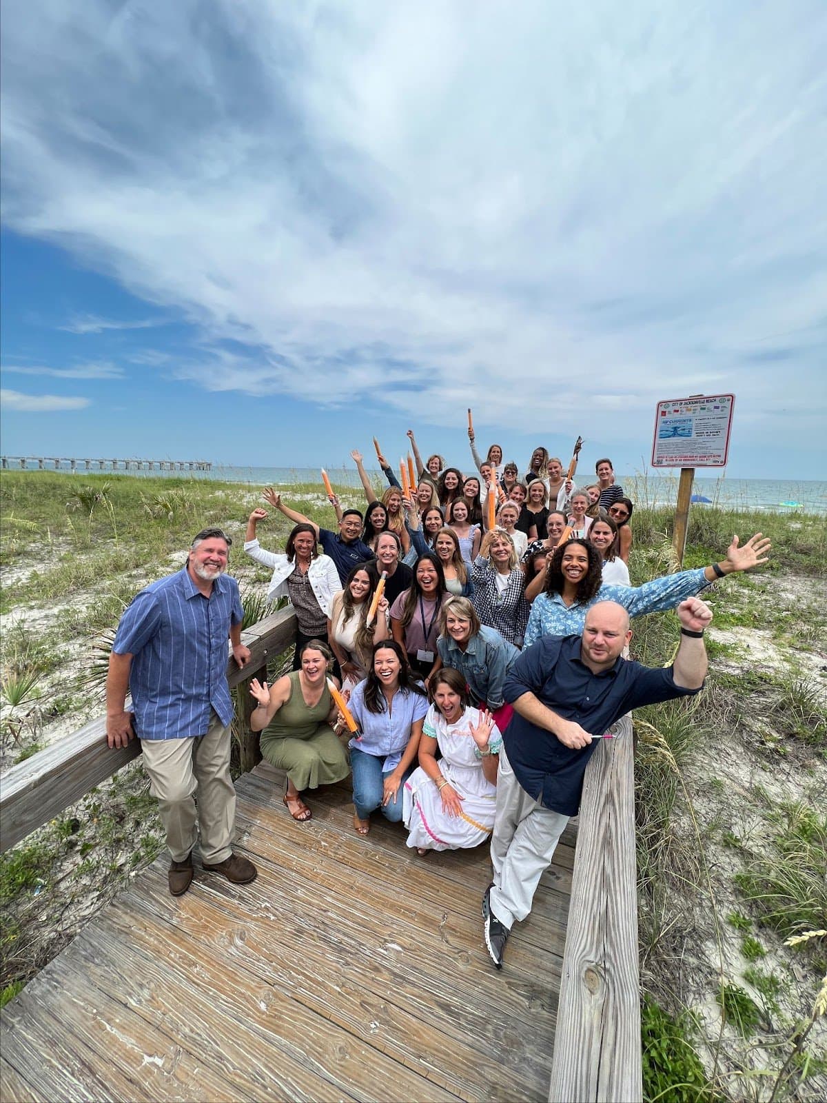 A group of teachers on vacation together at the beach.