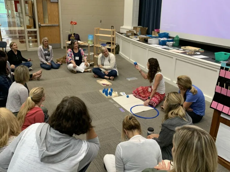 Cheri sitting with students