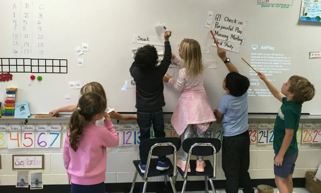 Children writing on a board