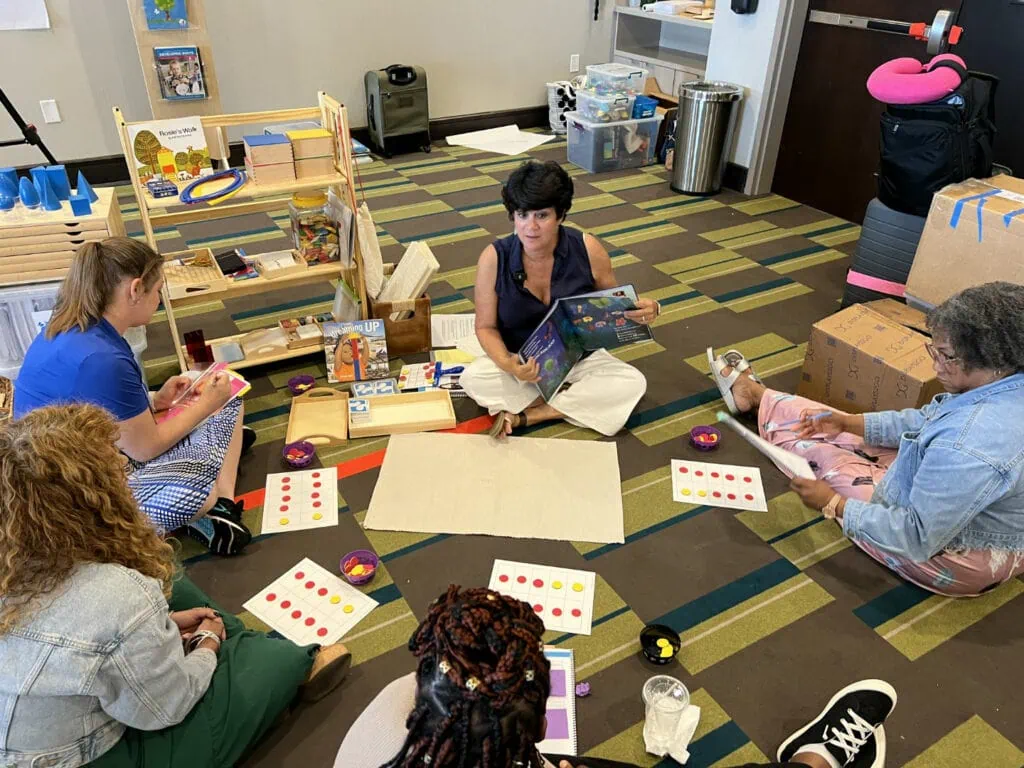 Woman teaching sitting on the floor