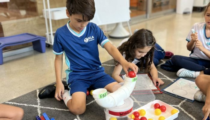 Child using different colored items in order to learn