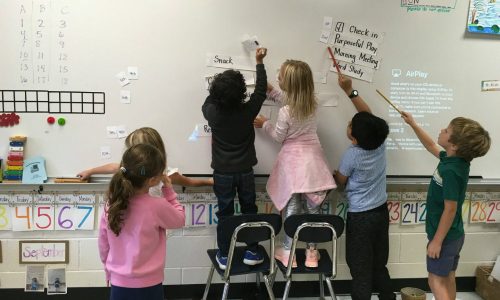 Children writing on a board